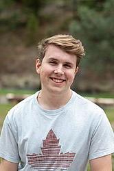 young man in front of a green background